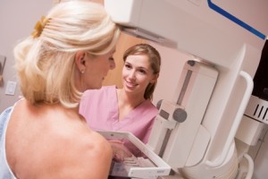 Nurse Assisting Patient Undergoing Mammogram