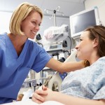 Young Female Patient Talking To Nurse In Emergency Room