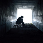 depressed man sitting in the tunnel