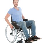 Full length portrait of disabled man on wheelchair over white background