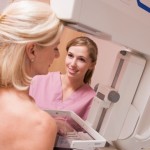 Nurse Assisting Patient Undergoing Mammogram