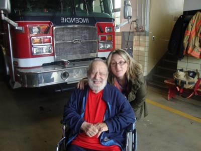 Jewish Eldercare resident Gerald Reinharz visiting the fire station with Recreation Specialist Josie DiBenedetto.