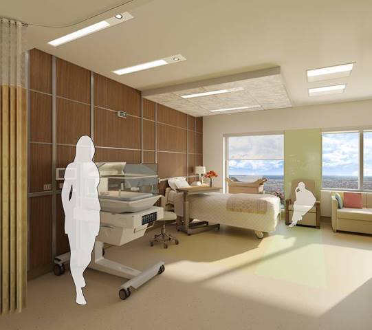The labor, delivery, and postpartum room features warm natural wood accents, floor-to-ceiling windows, and ample space for family members.