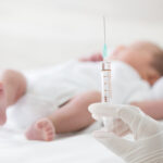 Syringe,With,Blur,Baby,Background.,Vaccine,Antivirus,For,Infant,Concept