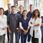 Team of healthcare workers at a hospital smiling to camera